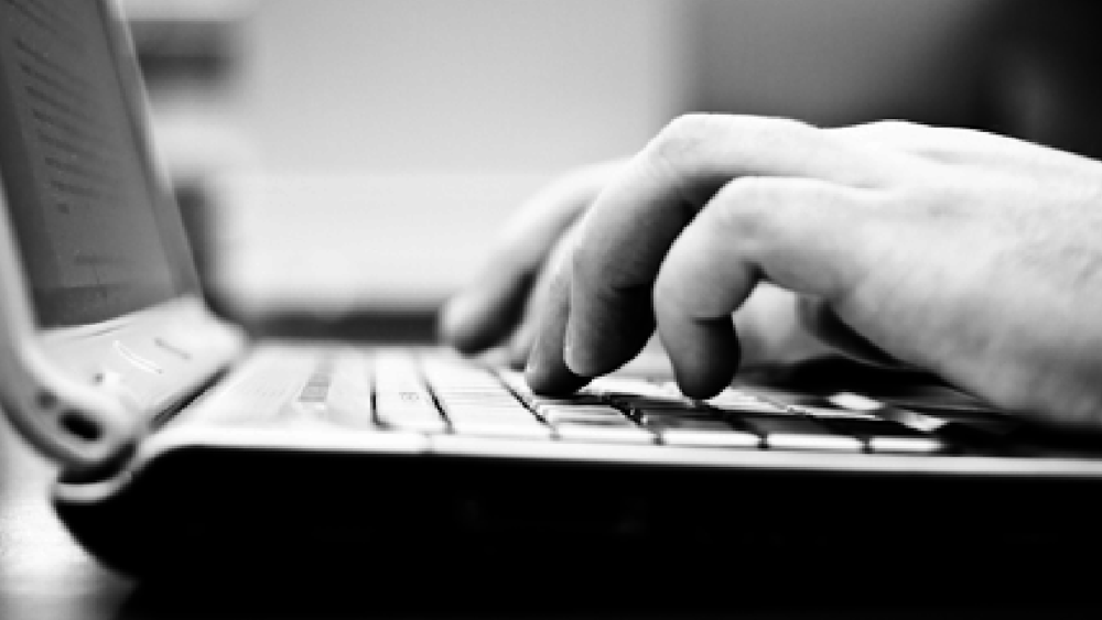 open-laptop-hands-typing-bw