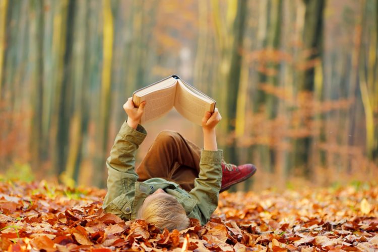 child-reading-a-book-colorful-autumn-in-the-park-hobbies-and-rest