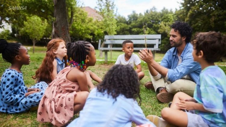 group-of-children-with-adult-teacher-talking