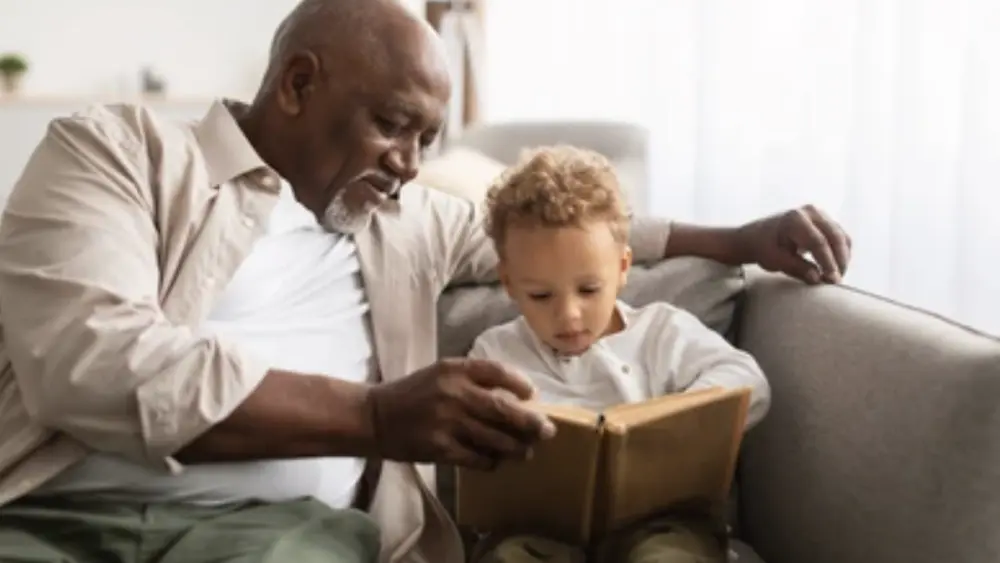 grandfather-reading-a-book-to-his-grandchild