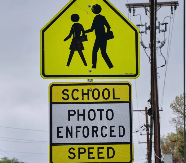 aschoolzonecrosswalksignwithaphotoenforcementsign-2