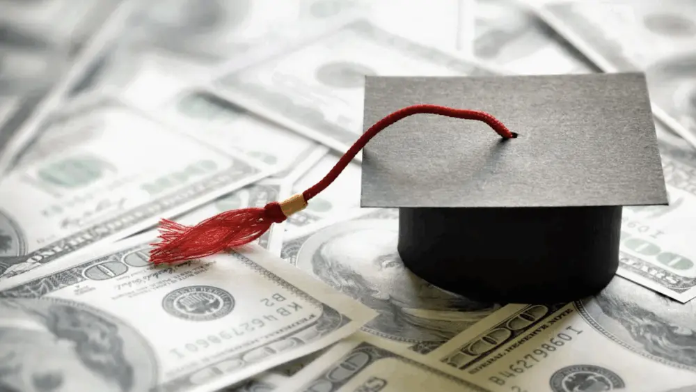 students-loan-funding-cuts-money-graduation-cap