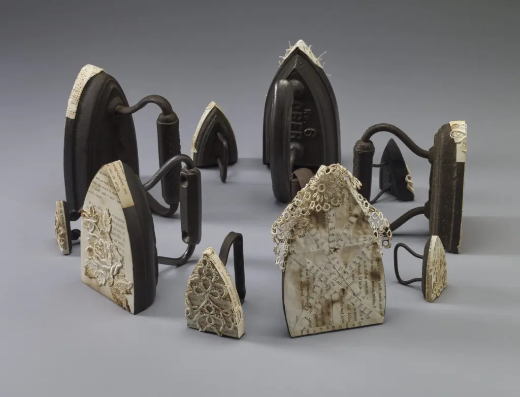 kunstadt_pressing-on-antique-sad-irons-scorched-lace-and-paper-pages-by-hannah-more-1791-circular-installation-7-x-22-x-2-2in