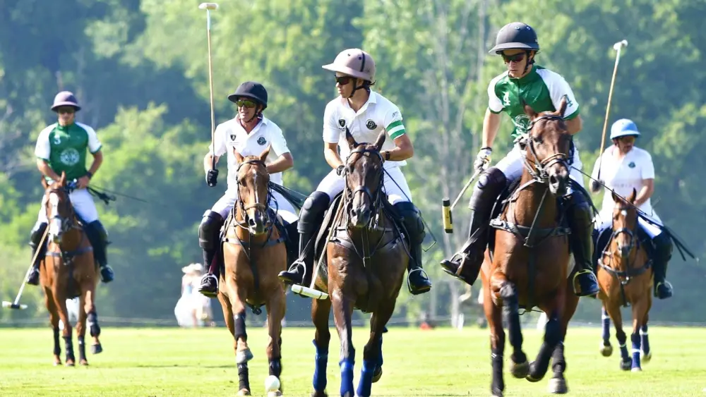 Round Hill (dark jersey) rallies against Greenwich Sound at last Sunday's match held at the Greenwich Polo Club (Photo courtesy of Claudia Suica)