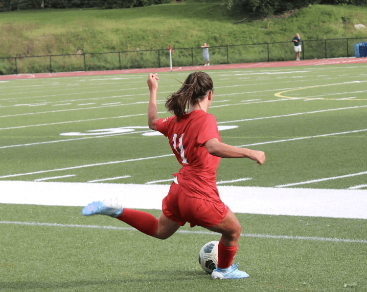 Cardinals sophomore Sophia Gega takes a free kick during the team’s 4-0 season-opening win vs. McMahon.