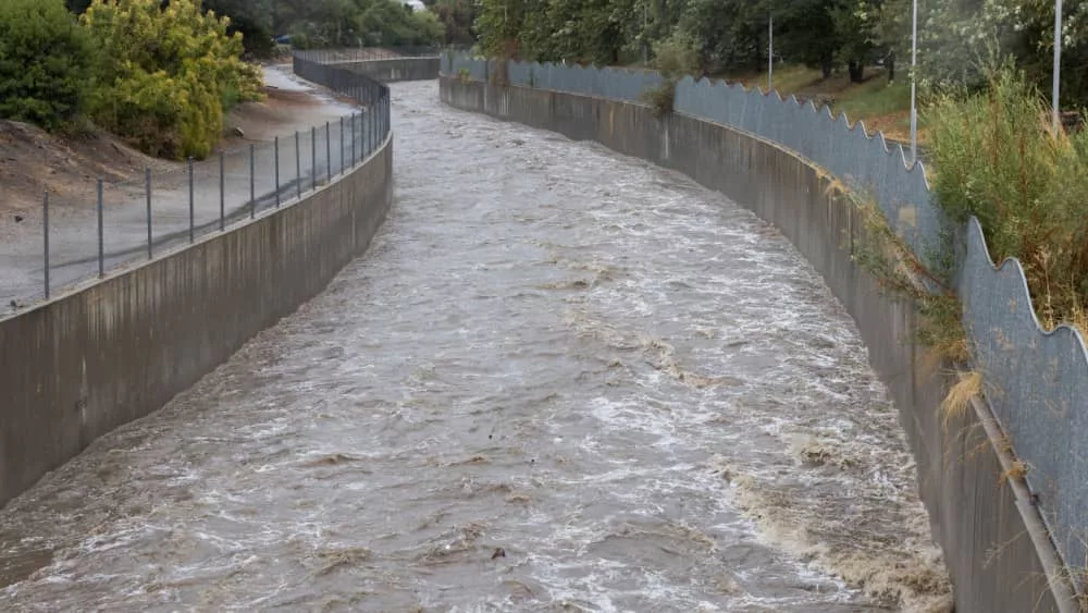 A high Los Angeles River rushes under Sepulveda Boulevard during flash flooding. August 20^2023