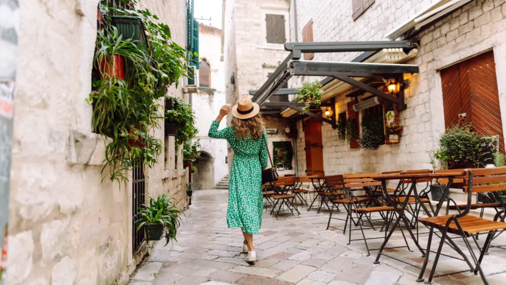 young-woman-in-beautiful-dress-walking-in-the-street-of-the-city-eurotrip-travel-tourism-fashion