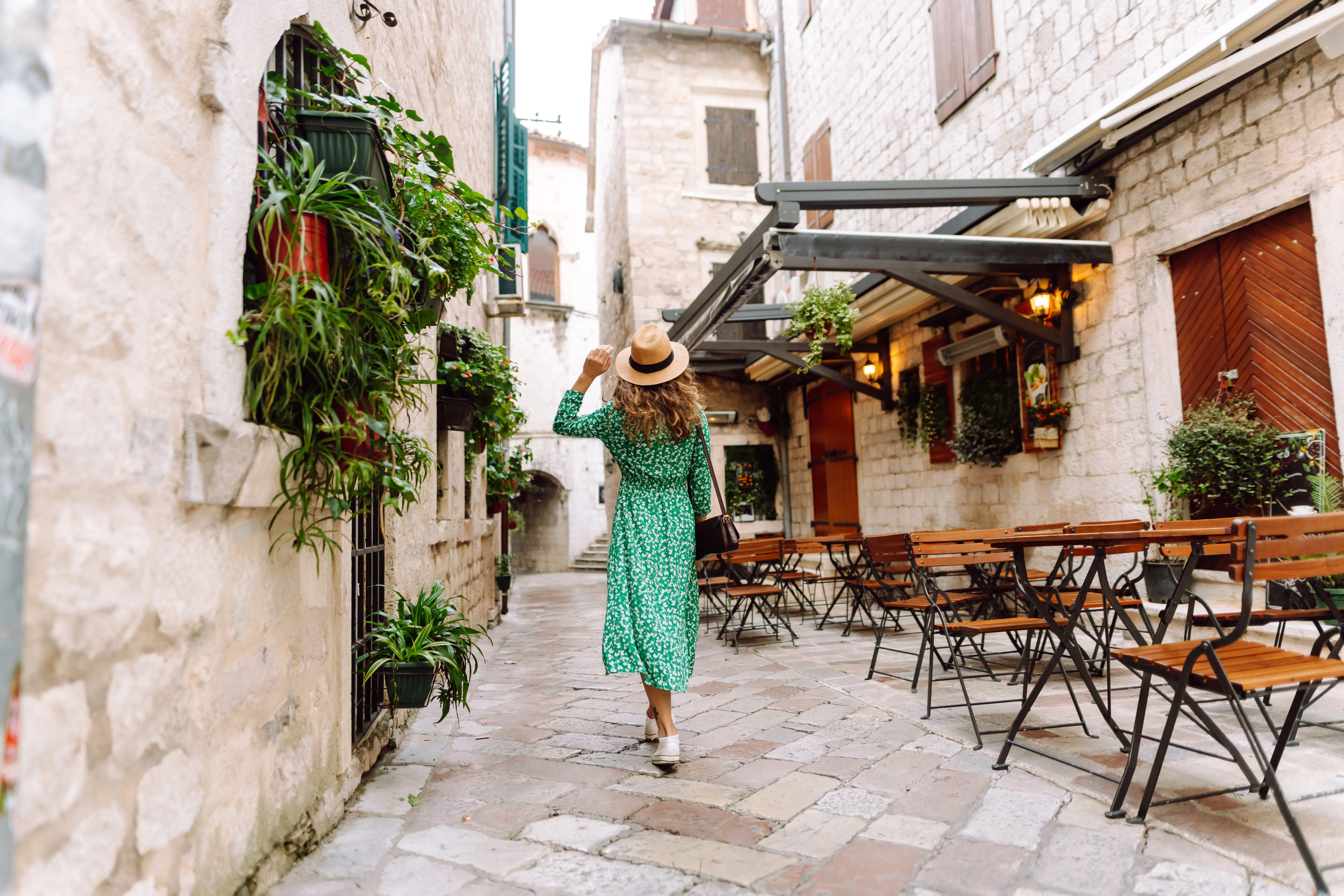 young-woman-in-beautiful-dress-walking-in-the-street-of-the-city-eurotrip-travel-tourism-fashion