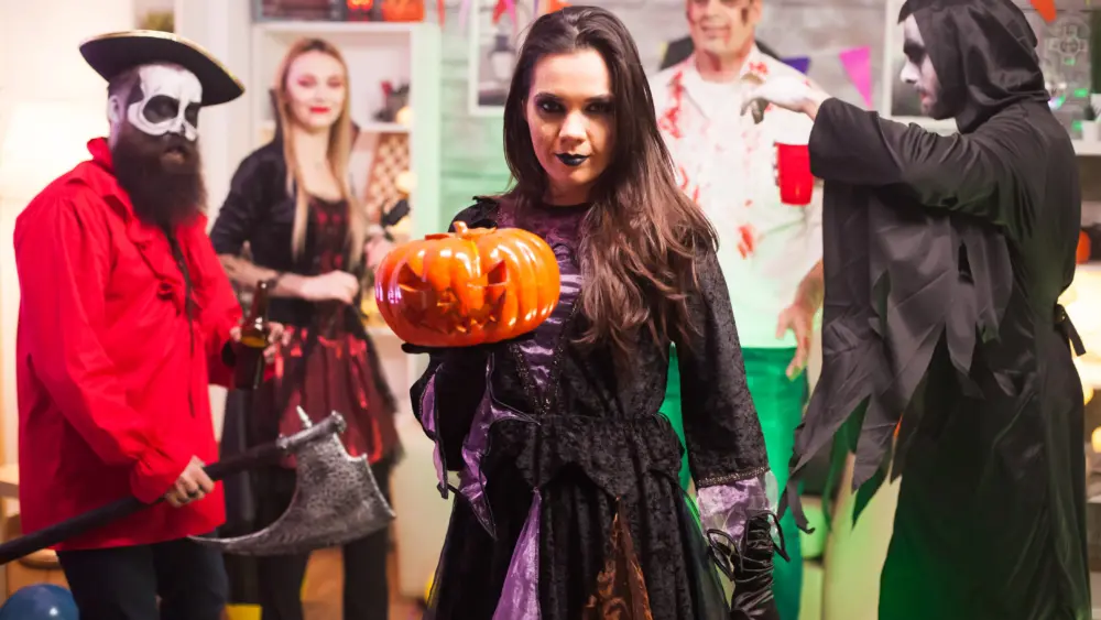 witch-holding-a-pumpkin-and-looking-at-the-camera