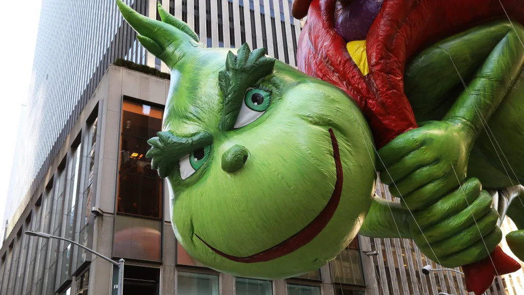 a-grinch-float-hovers-above-the-crowd-during-the-macys-thanksgiving-day-parade-in-manhattan
