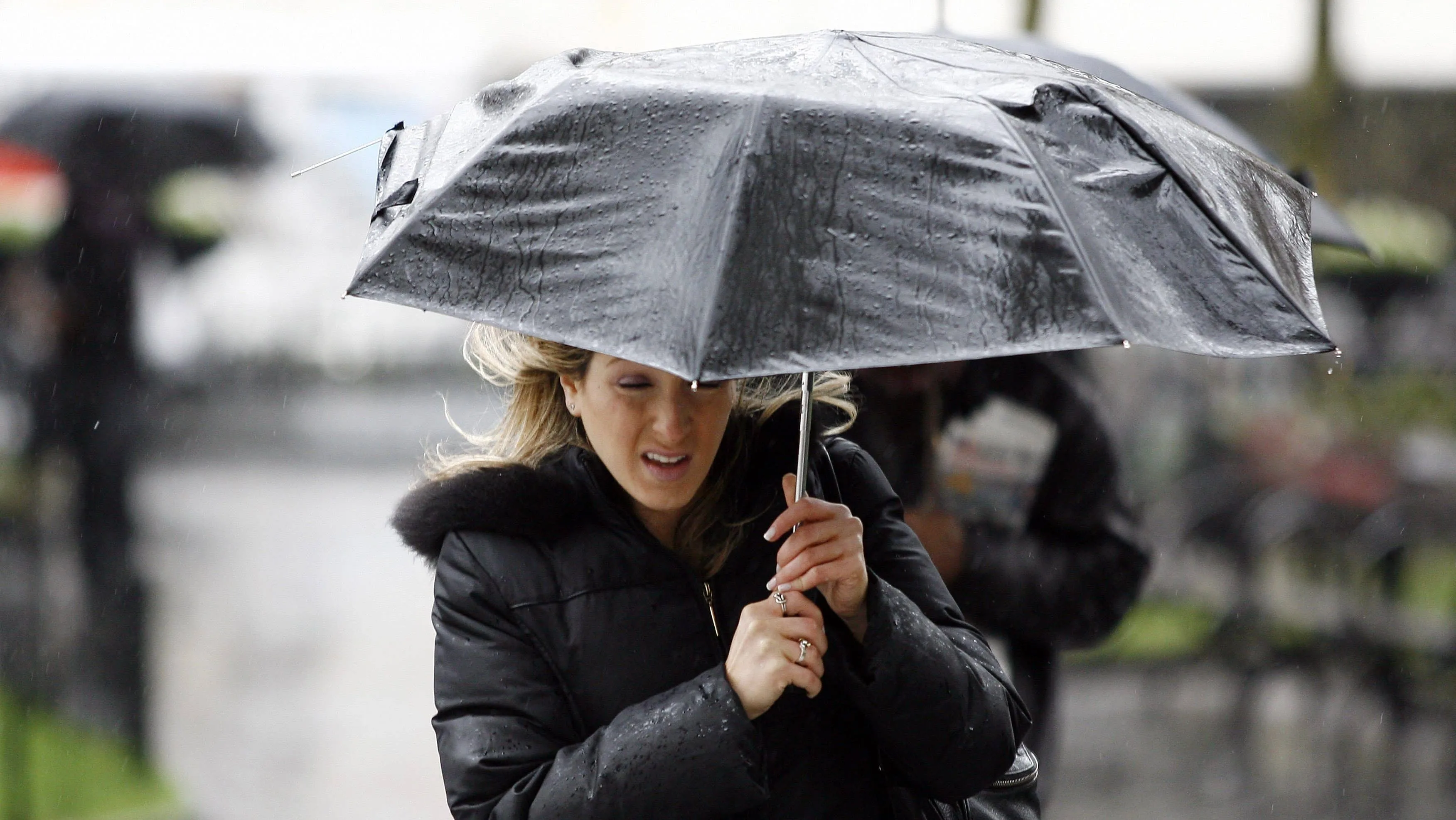 a-woman-makes-her-way-through-rainfall-in-new-york