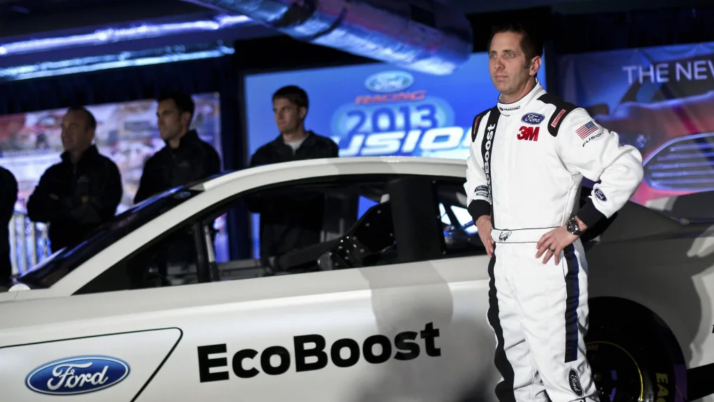 driver-biffle-poses-for-photographs-in-front-of-the-new-2013-ford-stock-car-after-an-announcement-during-the-nascar-media-tour-in-concord