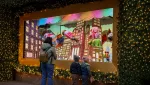 people-look-at-a-holiday-window-display-at-macys-herald-square-in-new-york