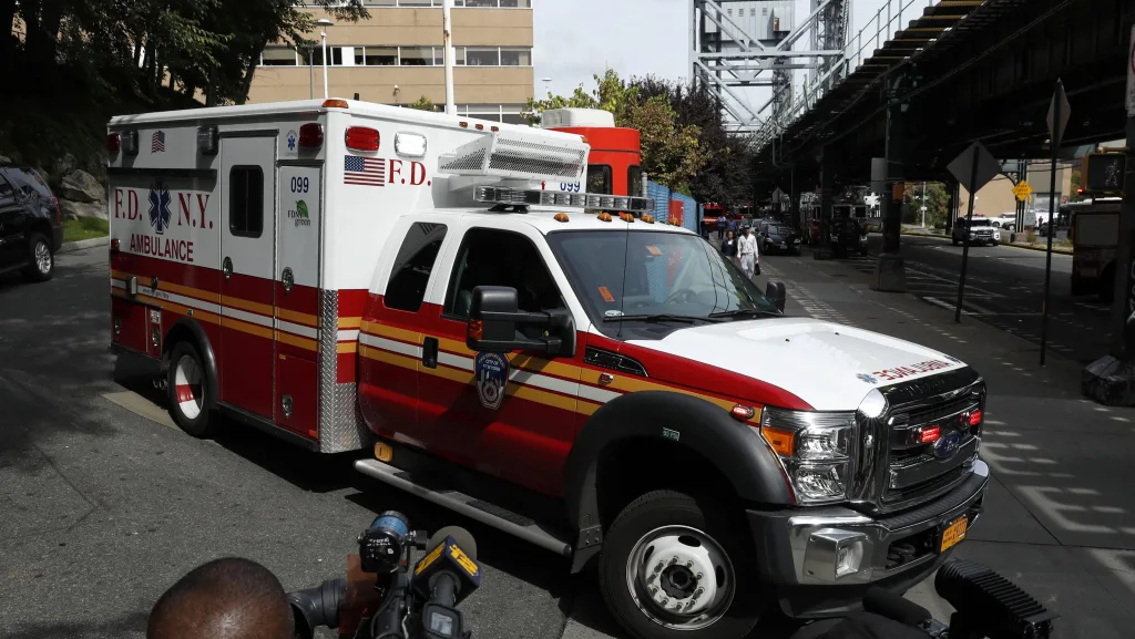 an-ambulance-carrying-the-body-of-fahy-drives-away-from-the-newyork-presbyterian-allen-hospital-past-members-of-the-media-in-new-york