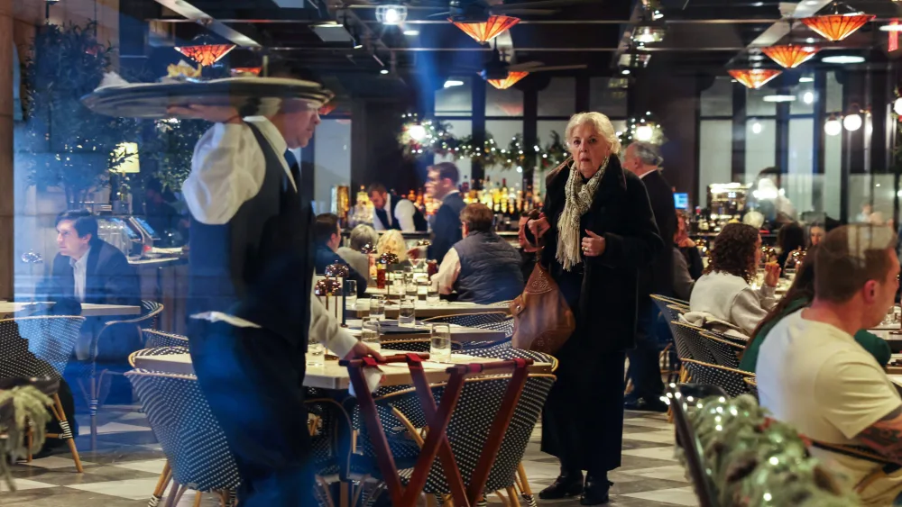 a-woman-waits-for-a-table-at-a-restaurant-at-grand-central-station-during-the-holiday-season-in-new-york-city