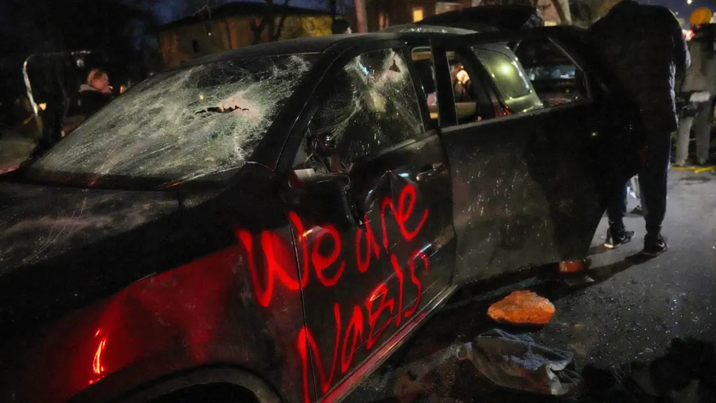 people-look-through-discarded-items-from-a-vandalized-car-in-minneapolis