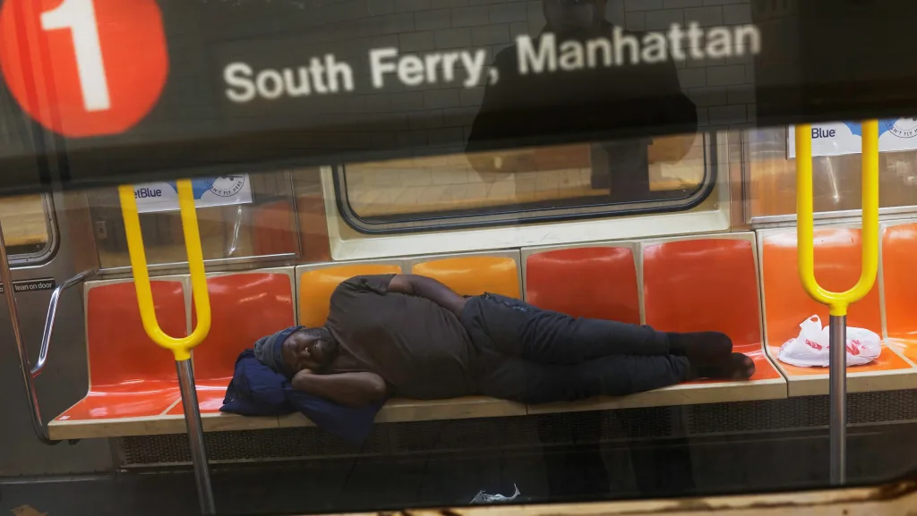 a-man-sleeps-on-a-new-york-subway-train-as-the-outbreak-of-the-coronavirus-disease-covid-19-continues-in-the-subways-of-new-york