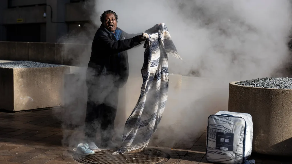 a-homeless-person-stands-among-steam-to-keep-warm-during-a-cold-day-in-washington