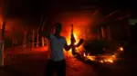 a-protester-reacts-as-the-u-s-consulate-in-benghazi-is-seen-in-flames