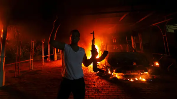 a-protester-reacts-as-the-u-s-consulate-in-benghazi-is-seen-in-flames
