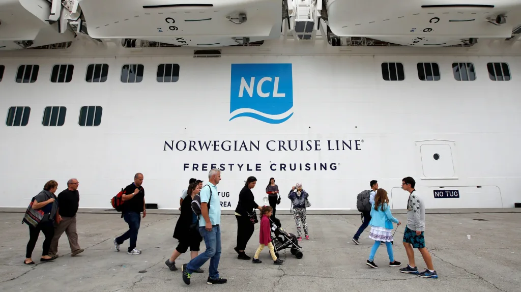 tourists-walk-beside-the-norwegian-epic-cruise-ship-before-boarding-in-marseille