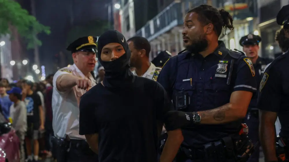 police-officers-detain-a-person-as-fans-gather-on-the-day-of-game-4-of-the-nba-finals-between-the-new-york-knicks-and-san-antonio-spurs-near-madison-square-garden-in-new-york-city