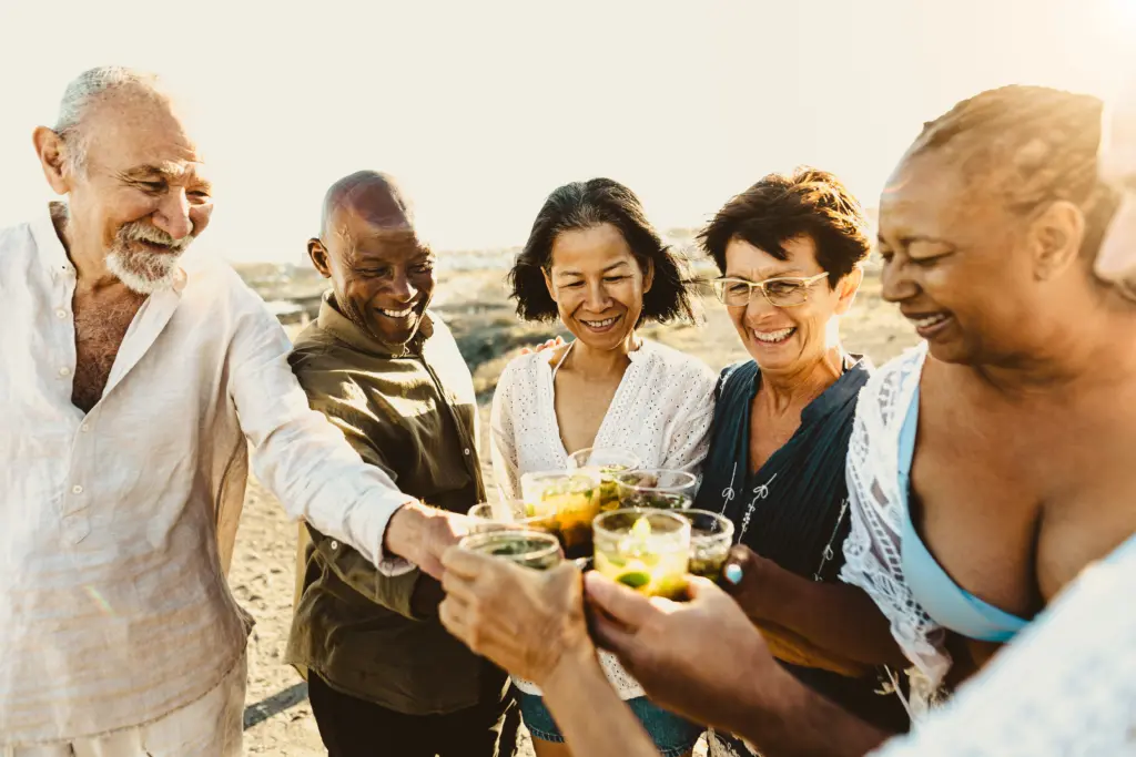 happy-multiracial-senior-friends-having-fun-drinking-and-toastin