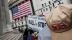 file-photo-a-wall-street-plate-is-seen-on-a-street-vendor-stall-outside-the-new-york-stock-exchange-nyse-in-new-york-city-3