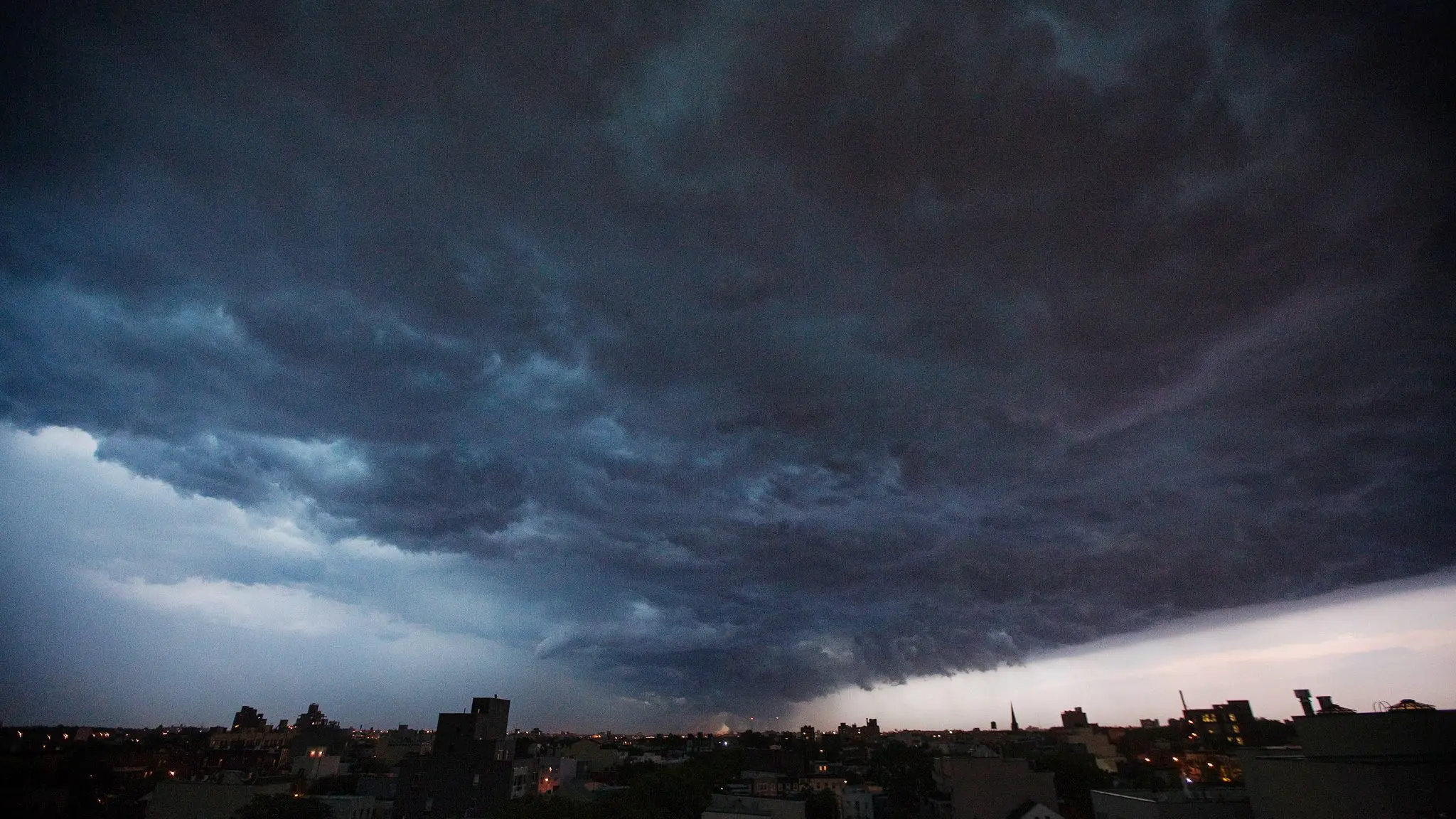 a-storm-cloud-begins-to-dump-rain-as-it-passes-over-the-brooklyn-borough-of-new-york-4