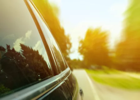 40250978-car-driving-fast-through-forest-road-speed-concept