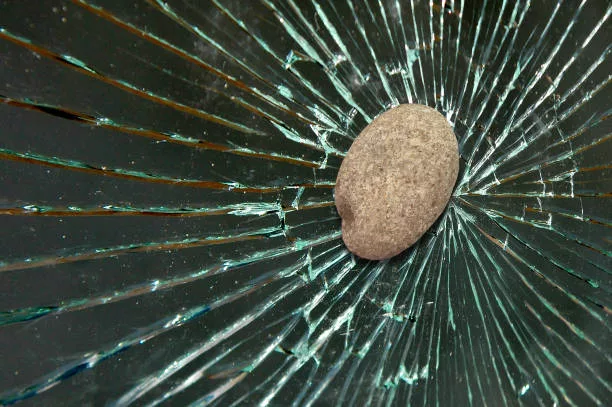 stone-hits-and-shatters-the-window-glass-of-a-house-car