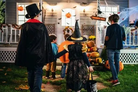 young-kids-trick-or-treating-at-night-during-halloween