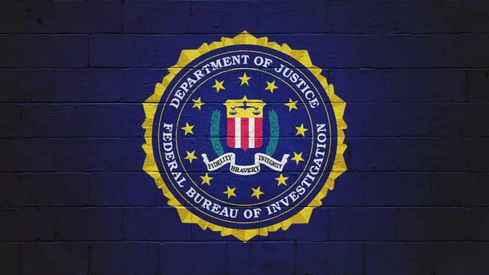 The FBI flag (Federal Bureau of Investigation) painted on a brick wall.