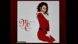 Mariah Carey's classic holiday album Merry Christmas from Spotify's interface on an Apple iPad. The currently selected track is "All I Want for Christmas Is You".