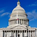 Washington DC Capitol Building facade under blue sky with clouds