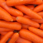 fresh carrots piled high on a market