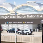 Sign for Washington National Airport with the airport terminal in the background. Washington D.C. USA- July 12th^ 2021