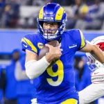 Los Angeles Rams Matthew Stafford #9 escapes a tackle-attempt by Arizona Cardinals Julian Okwara #58 during an NFL football game at SoFi Stadium^ Dec. 28^ 2024^ in Inglewood^ Calif.