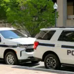 Police patrol cars used by the FBI parked on a street outside the J Edgar Hoover headquarters building in downtown Washington DC. Washington DC^ USA - 30 April 2024