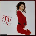 Mariah Carey's classic holiday album Merry Christmas from Spotify's interface on an Apple iPad. The currently selected track is "All I Want for Christmas Is You".