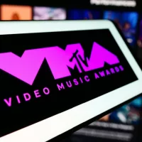 Mobile phone with logo of award show MTV Video Music Awards (VMA) in front of website. Focus on center-left of phone display. Unmodified photo.