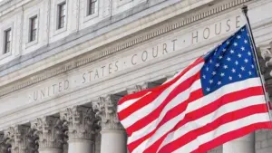 American flag waving in the wind in front of United States Court House in New York