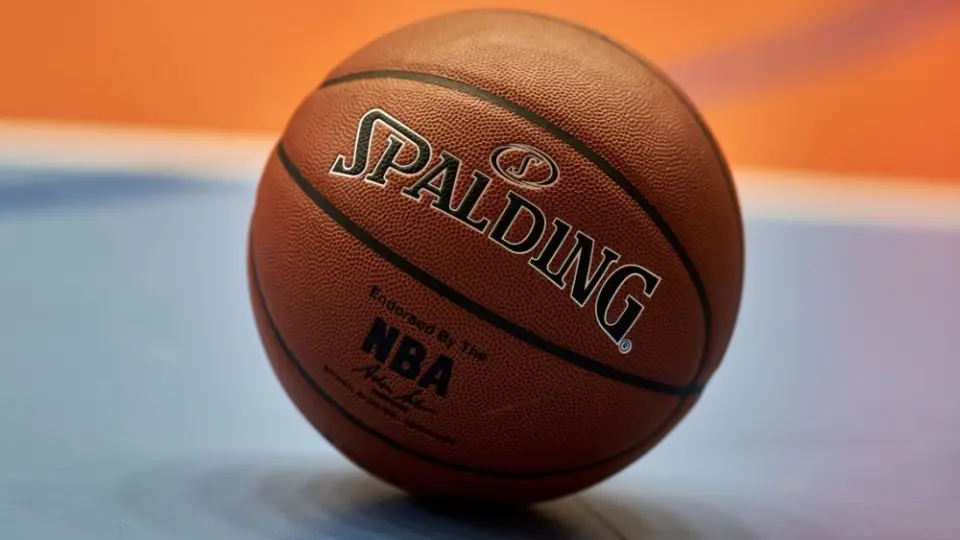 Gdansk^ Poland - 08 02 2024: Close-up of a Spalding NBA basketball resting on a blue and orange court^ focusing on the texture of the ball and the surrounding vibrant colors of the court.