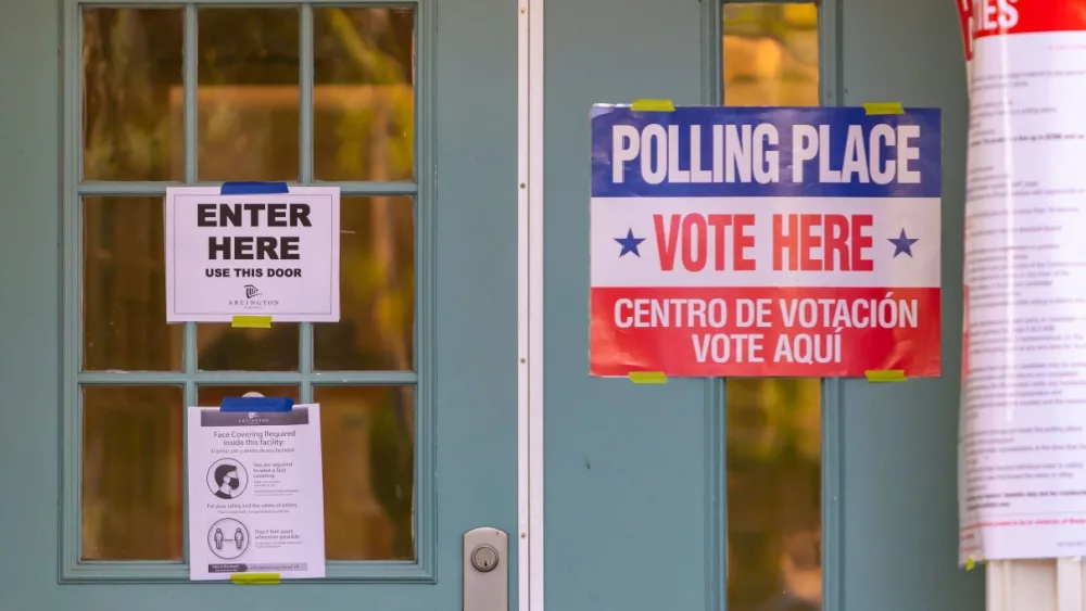 Signs on polling place door during voting on presidential election day in northern Virginia. ARLINGTON^ VIRGINIA^ USA - NOVEMBER 3^ 2020