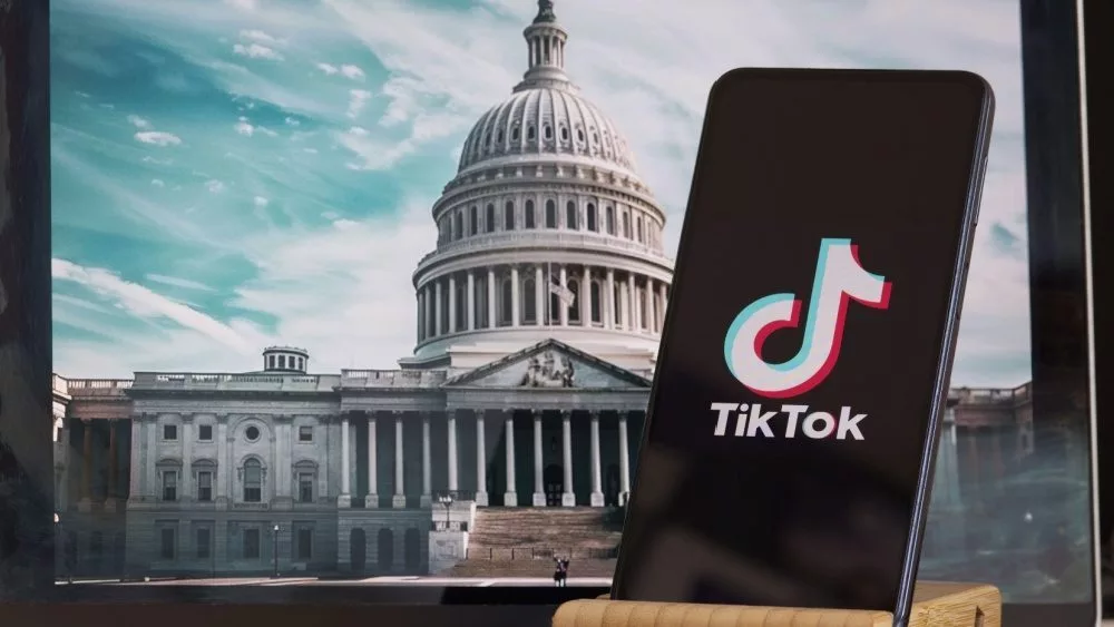 TikTok sign is sharp in the foreground^ while American Congress building is blurred in the background^ concept for TikTok ban in the United States^ USA^ March 8^ 2024