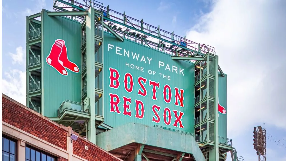View of the historic architecture of the Famous Fenway Park Stadium in Boston^ MA^ USA showcasing its huge sign^ old brick walls^ and entrances on Lansdowne street. Boston^ MA^ USA - March 1^ 2023