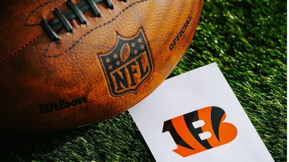 Cincinnati Bengals NFL team Logo and American football ball on Green Grass. CINCINNATI^ USA^ FEBRUARY 10^ 2025