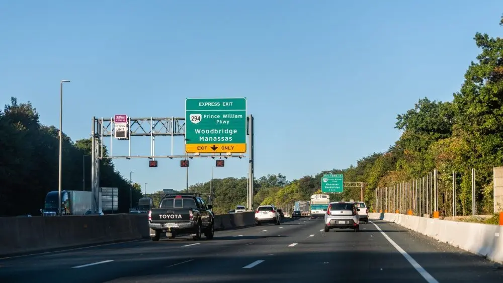 Highway i-95 interstate road in Virginia with cars on commute in morning traffic near Washington DC and sign for Prince William Parkway and ManassasWoodbridge^ USA - October 18^ 2021: