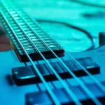 Electric guitar on the floor in blue lighting close up