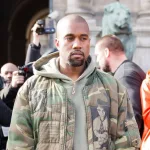 Kanye West iin front of the Dries van noten fashion show. Paris Hotel de ville.